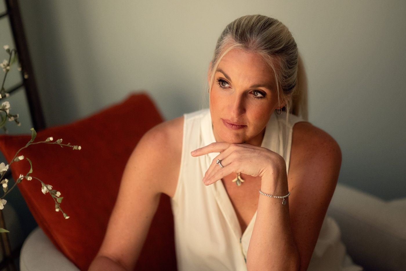 Tami Watson seated, resting her chin on her hand